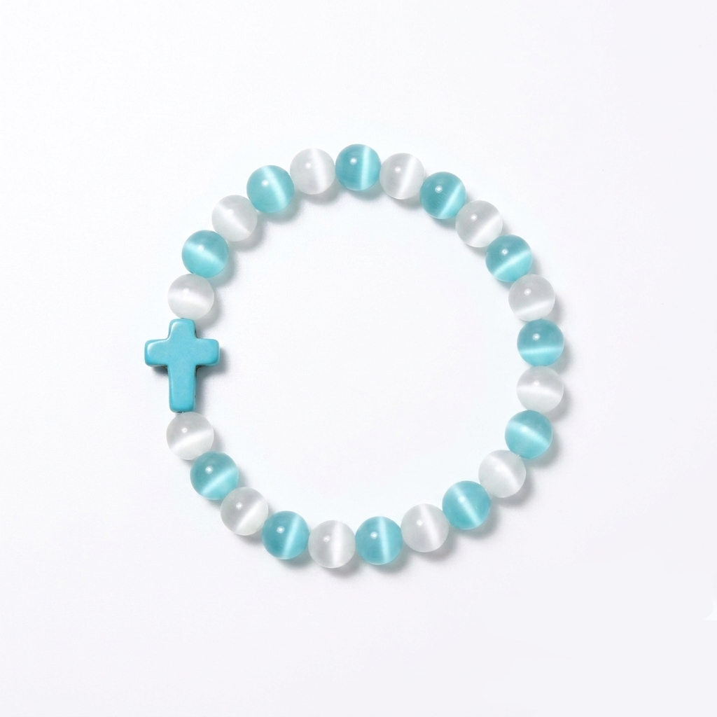 The Aether Cross energy bracelet by SpiritPalette displayed on a clean white background, showcasing cyan and white cat-eye gemstone beads with a turquoise cross.