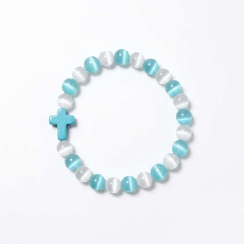 The Aether Cross energy bracelet by SpiritPalette displayed on a clean white background, showcasing cyan and white cat-eye gemstone beads with a turquoise cross.