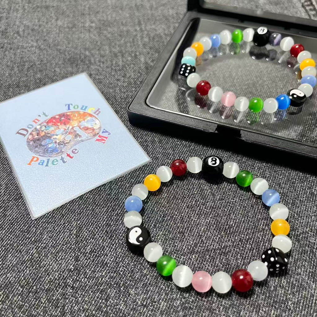 Premium black floating gift box packaging for the SpiritPalette Chroma Rebel multi-color 8-ball and dice bracelet with a signature brand collector card.